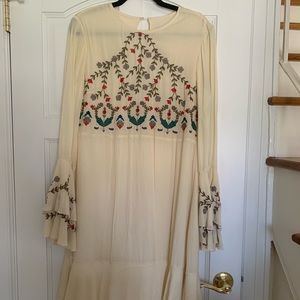 Embroidered cream dress with ruffle sleeve and hem